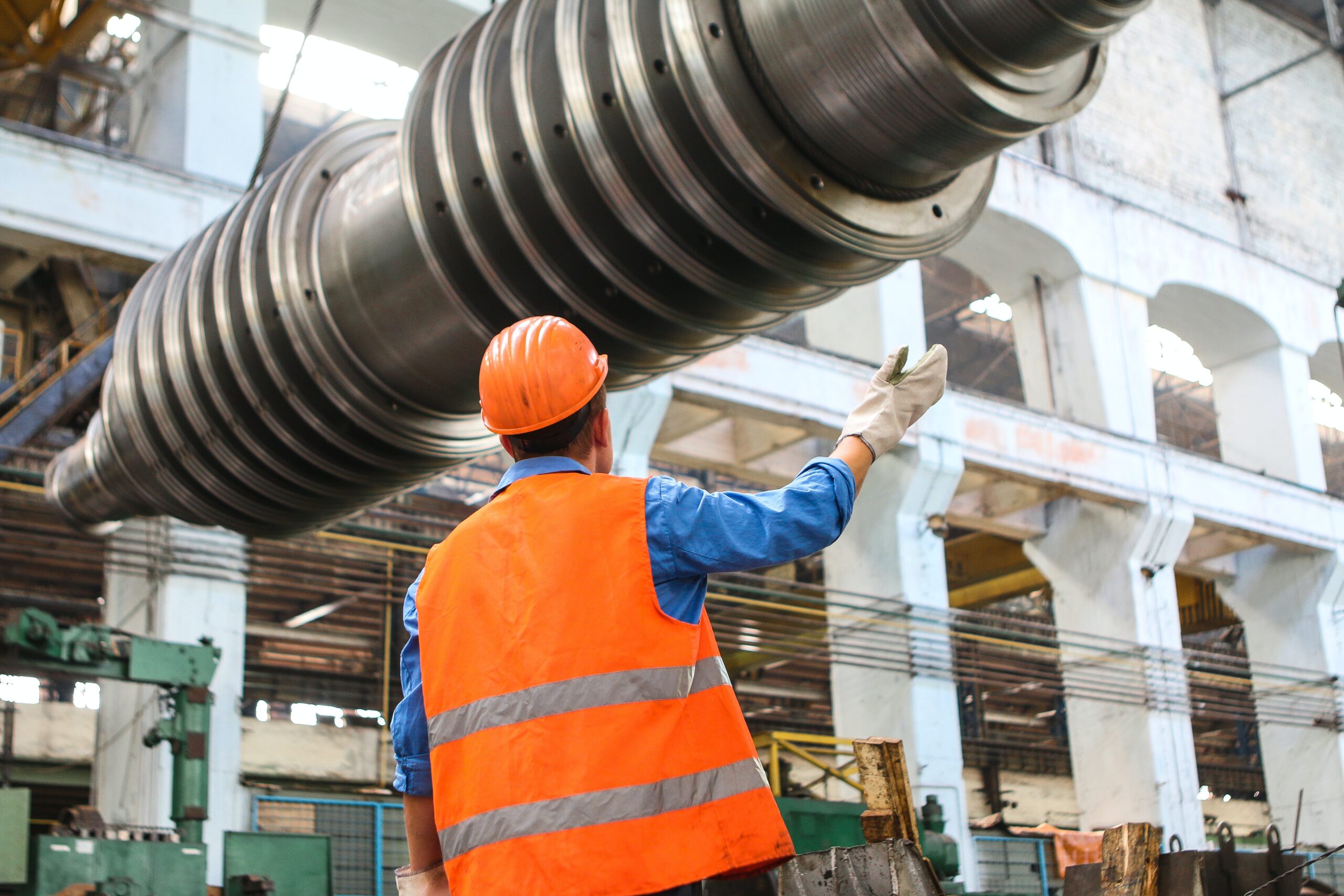 construction worker installing a big machine