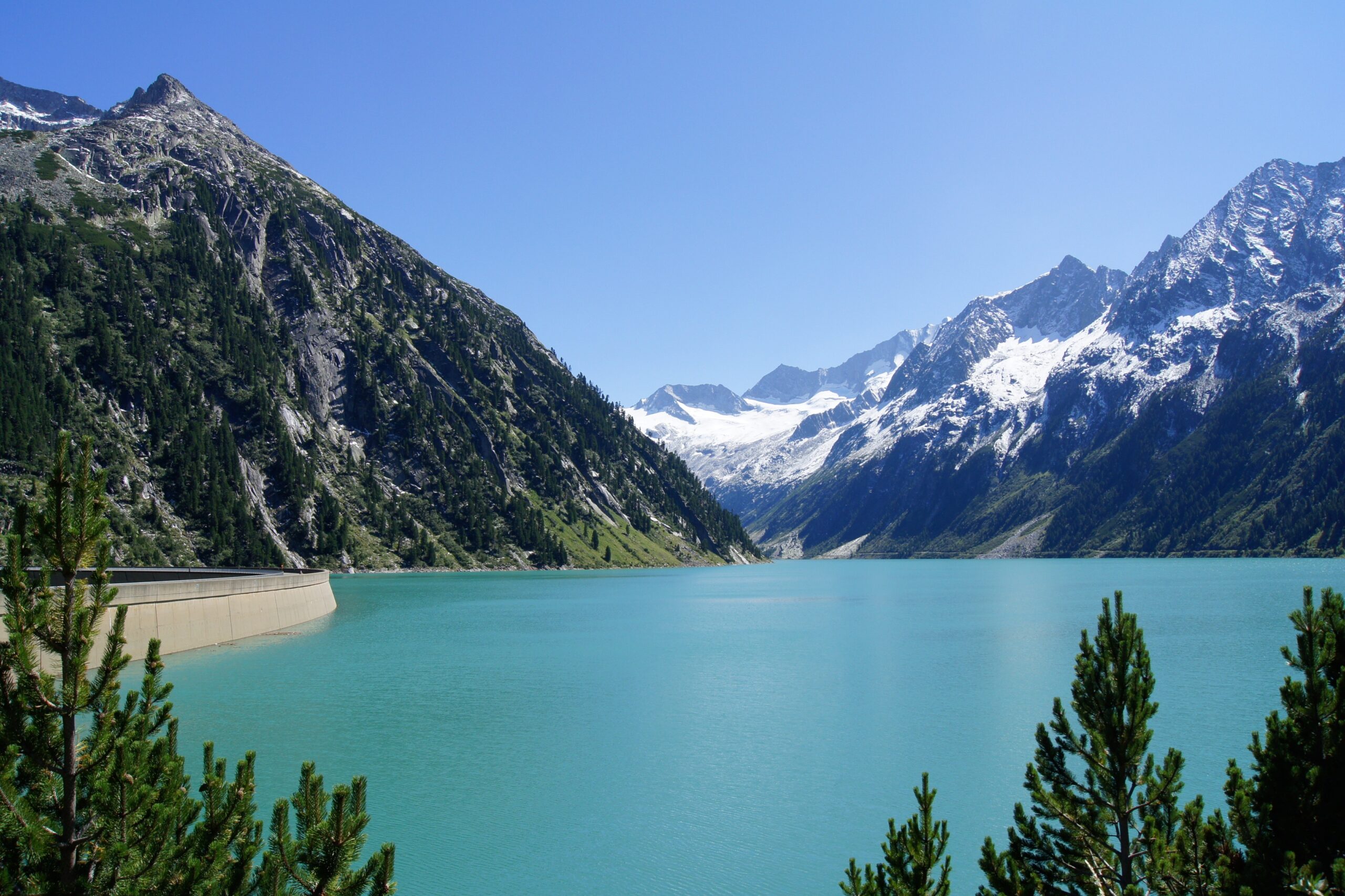 amazing landscape of a lake and a dam with mountains