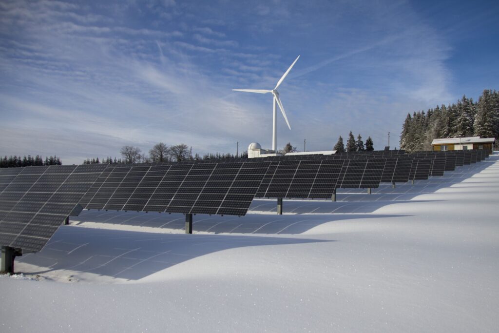 solar panels placed on a field and covered with snow 